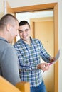 Service employee with tenant at doorway Royalty Free Stock Photo
