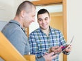 Service employee with tenant at doorway Royalty Free Stock Photo