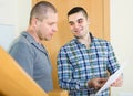 Service employee with tenant at doorway Royalty Free Stock Photo