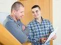 Service employee with tenant at doorway Royalty Free Stock Photo