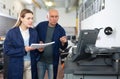 Service engineer conducts training on work on copiers of an office worker Royalty Free Stock Photo