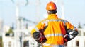 Service engineer standing in front of heat electropower station