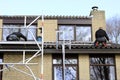 Installing solar panels on the rooftop of a house Royalty Free Stock Photo