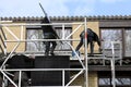 Installing solar panels on the rooftop of a house Royalty Free Stock Photo