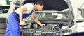 Service and inspection of a car in a workshop - mechanic inspect Royalty Free Stock Photo