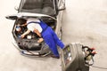 Service and inspection of a car in a workshop - mechanic inspect