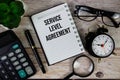 Service Level Agreement (SLA) text on notepad, Business and Financial concept background Royalty Free Stock Photo