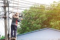 Service man climbing high bamboo stair wooden for service maintenance upgrade speed fiber optic line. technician professional