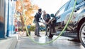 Service man helping woman cleaning her auto in car wash Royalty Free Stock Photo