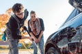 Service man helping woman cleaning her auto in car wash Royalty Free Stock Photo