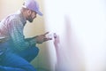 Service man installing power socket in wall