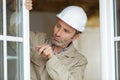 service man installing window with screwdriver Royalty Free Stock Photo