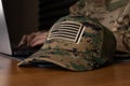 A service member is using a laptop, possibly for administrative tasks Royalty Free Stock Photo