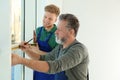 Service men measuring window for installation Royalty Free Stock Photo