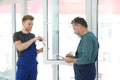 Service men measuring window for installation Royalty Free Stock Photo