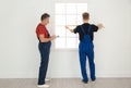 Service men measuring window for installation Royalty Free Stock Photo
