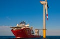 Service operational vessel standing by wind turbine Royalty Free Stock Photo