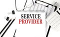 SERVICE PROVIDER word on notepad with clipboard , chart and calculator, business concept