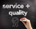 Service and Quality Text on Board with Ribbon Royalty Free Stock Photo