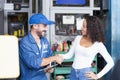 Service repair maintenance concept. The car mechanic is explaining the operation of the engine. Smiling mechanic shaking hands at Royalty Free Stock Photo