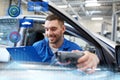 Mechanic man with diagnostic scanner at car shop Royalty Free Stock Photo