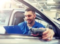 Mechanic man with diagnostic scanner at car shop Royalty Free Stock Photo