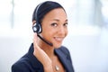 Service with a smile. An attractive call centre operator smiling at the camera. Royalty Free Stock Photo