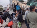 A service vehicle is moving through the mob in a marketplace (Press Photograph)