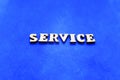 Service white wooden letters on blue background