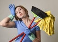 Service woman in washing rubber gloves carrying cleaning broom m