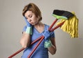 Service woman in washing rubber gloves carrying cleaning broom m