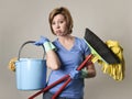 Service woman in washing rubber gloves carrying cleaning bucket