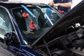 Service workers replacing car front windshield. Royalty Free Stock Photo