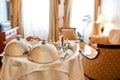 Service that you deserve. Luxurious Room Service. Breakfast in luxury hotel room delivered by waiter. Meals under silver