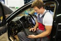 Serviceman in a car workshop