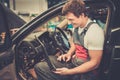 Serviceman in a car workshop