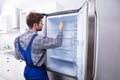 Serviceman Checking An Refrigerator