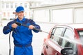 Serviceman With High Pressure Water Jet Washing Car Royalty Free Stock Photo