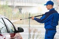 Serviceman With High Pressure Water Jet Washing Car Royalty Free Stock Photo