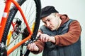 serviceman installing assembling or adjusting bicycle gear on wh Royalty Free Stock Photo