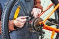 serviceman installing assembling or adjusting bicycle gear on wh Royalty Free Stock Photo