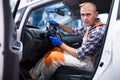 Serviceman making car diagnostics in a workshop