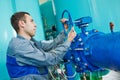 Serviceman operating industrial water purification or filtration equipment Royalty Free Stock Photo