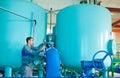 Serviceman operating industrial water purification or filtration equipment Royalty Free Stock Photo