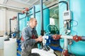 Serviceman operating industrial water purification or filtration equipment