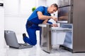 Serviceman Repairing Refrigerator Royalty Free Stock Photo