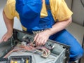 Serviceman replacing thermostat in the electric oven