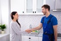 Serviceman Shaking Hands With Woman