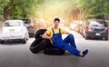 Serviceman in uniform sitting on a pile of tires