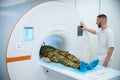 MR technologist preparing military man for magnetic resonance imaging test Royalty Free Stock Photo